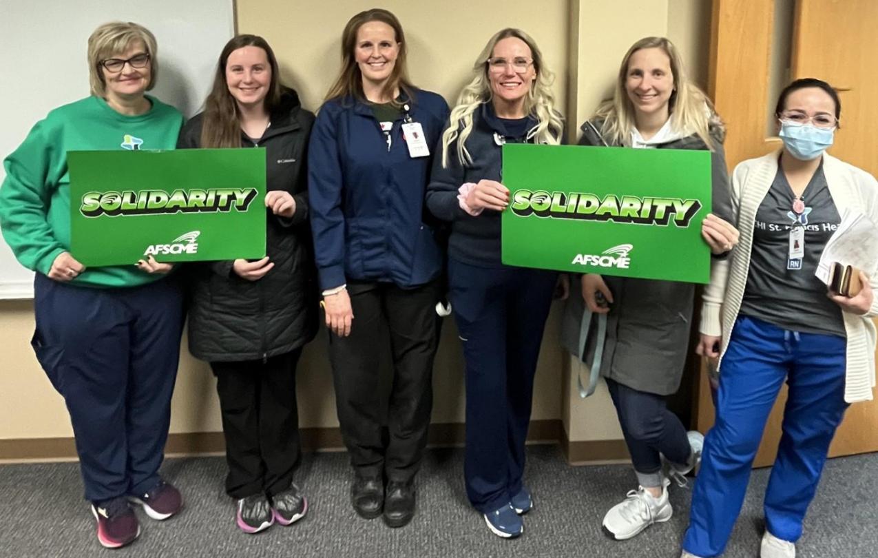 Group of nurses holding union signs
