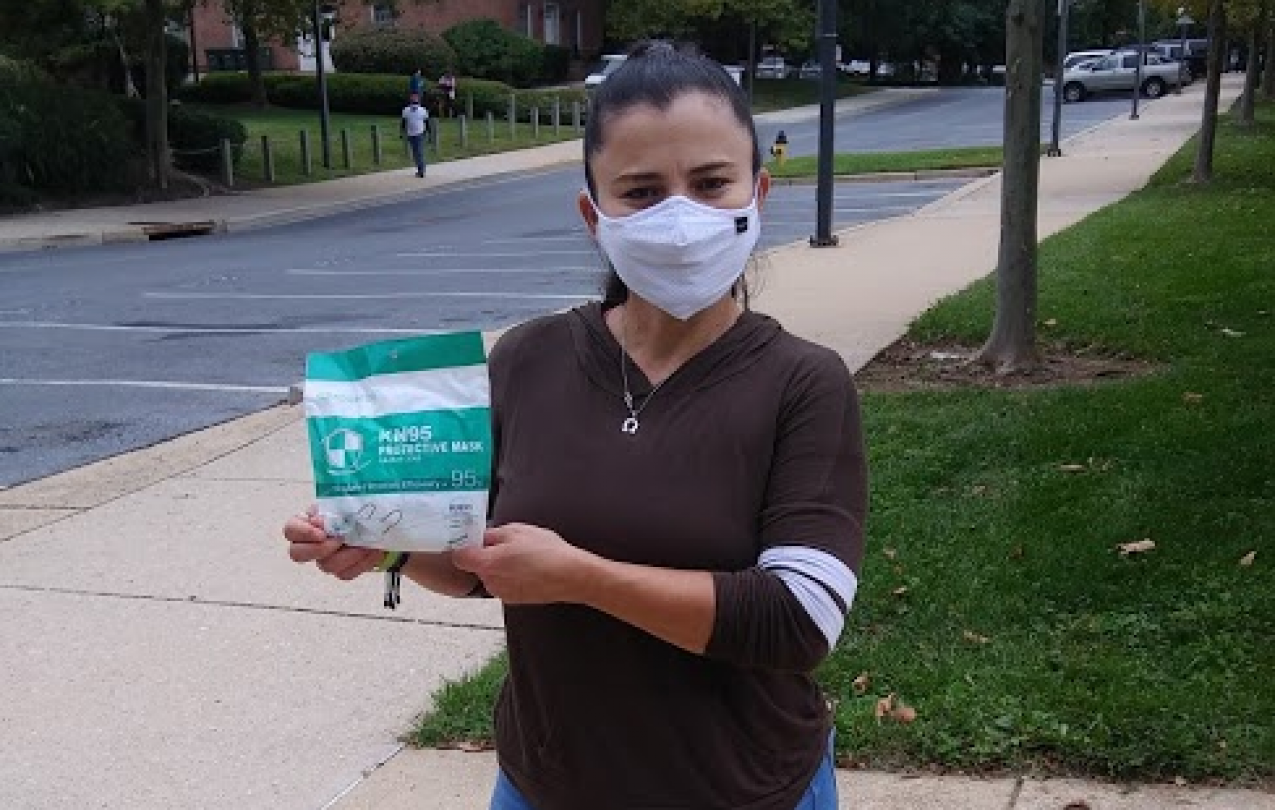 AFSCME member Maria Ayala holds up masks