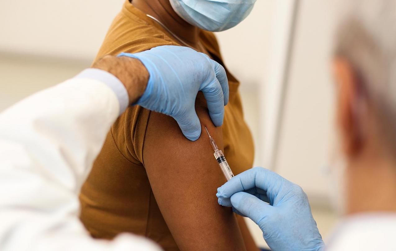 Doctor administering a vaccine to a patient