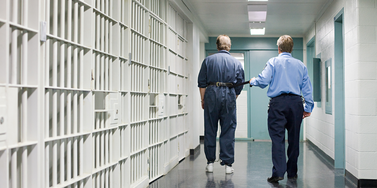 Stock image of a corrections officer escorting an inmate. Photo credit: Getty.