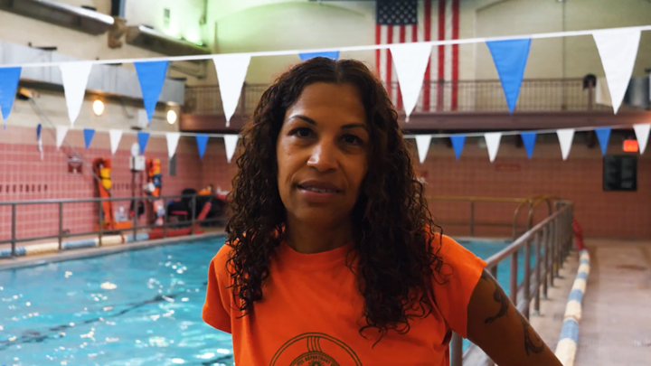 Lifeguard Rosa Pena standing near a pool