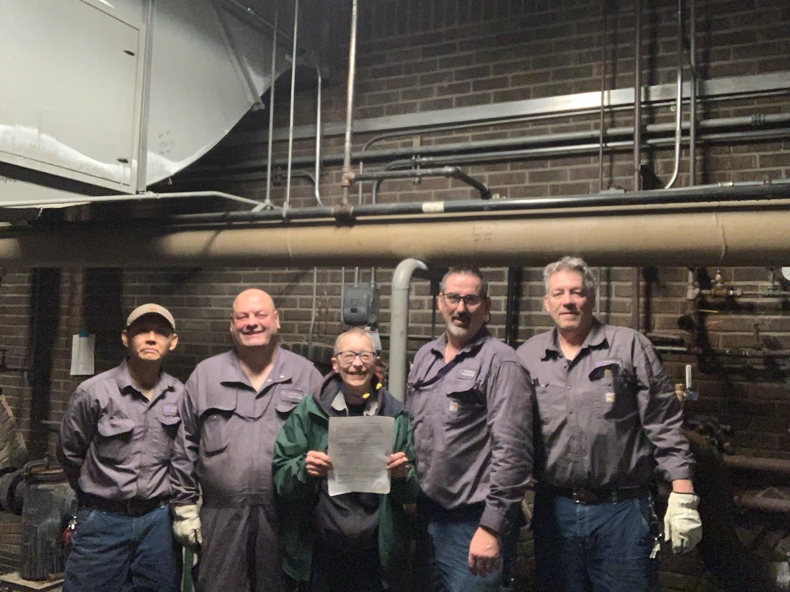 Left to right, UW plumbers & steamfitters Baldwin Tran, Neal Hill, Paula Lukaszek, Eric Broekhuizen and Mark Mayfield pose with their grievance settlement