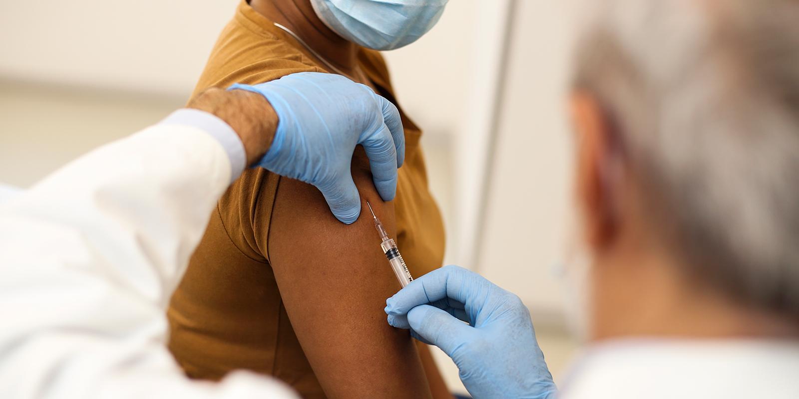 Doctor administering a vaccine to a patient