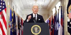 President Biden speaking at a podium in the White House.