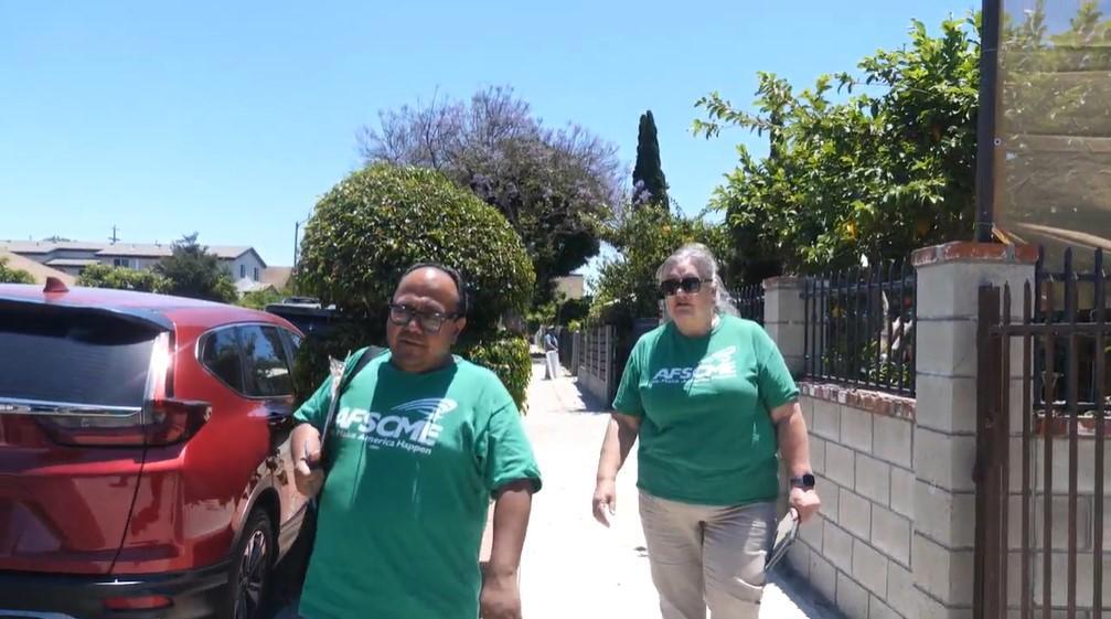 Colleen Juarez walking with Jonathan Diaz during a volunteer member organizer blitz.