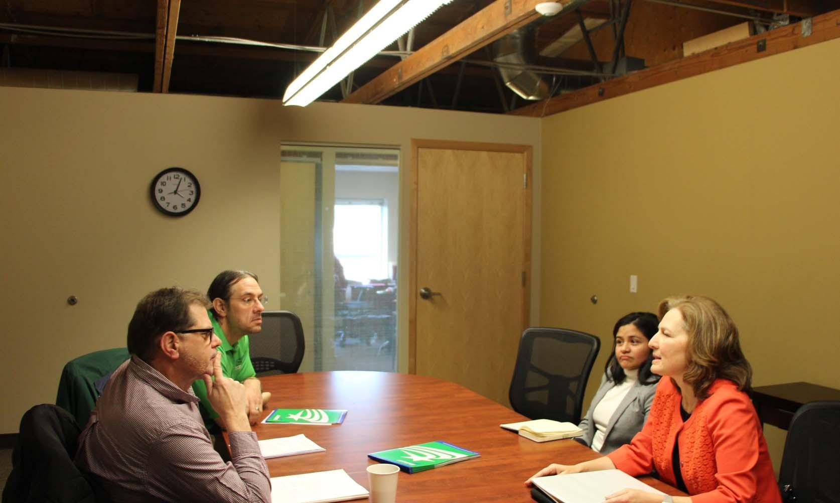 Congressperson Kim Schrier, WFSE President Mike Yestramski and staff sit and talk at a conference table