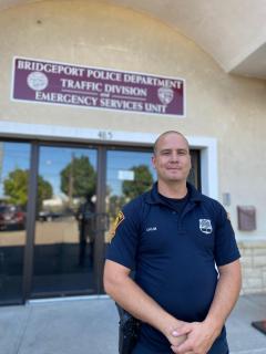 Orum standing in front of the Bridgeport PD Traffic Division building entrance. Photo credit: Aaron Gallant/AFSCME.