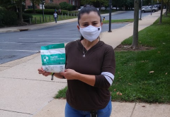 AFSCME member Maria Ayala holds up masks